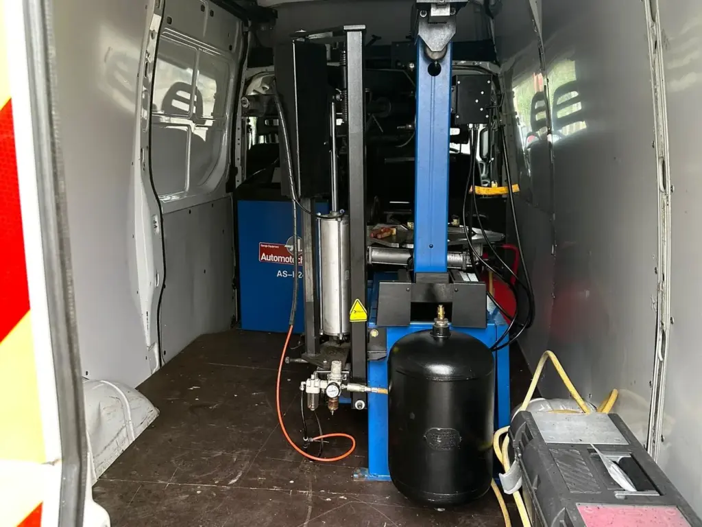 Inside the AMD mobile tyre van, with a tyre changer and wheel balancer fitted in the back